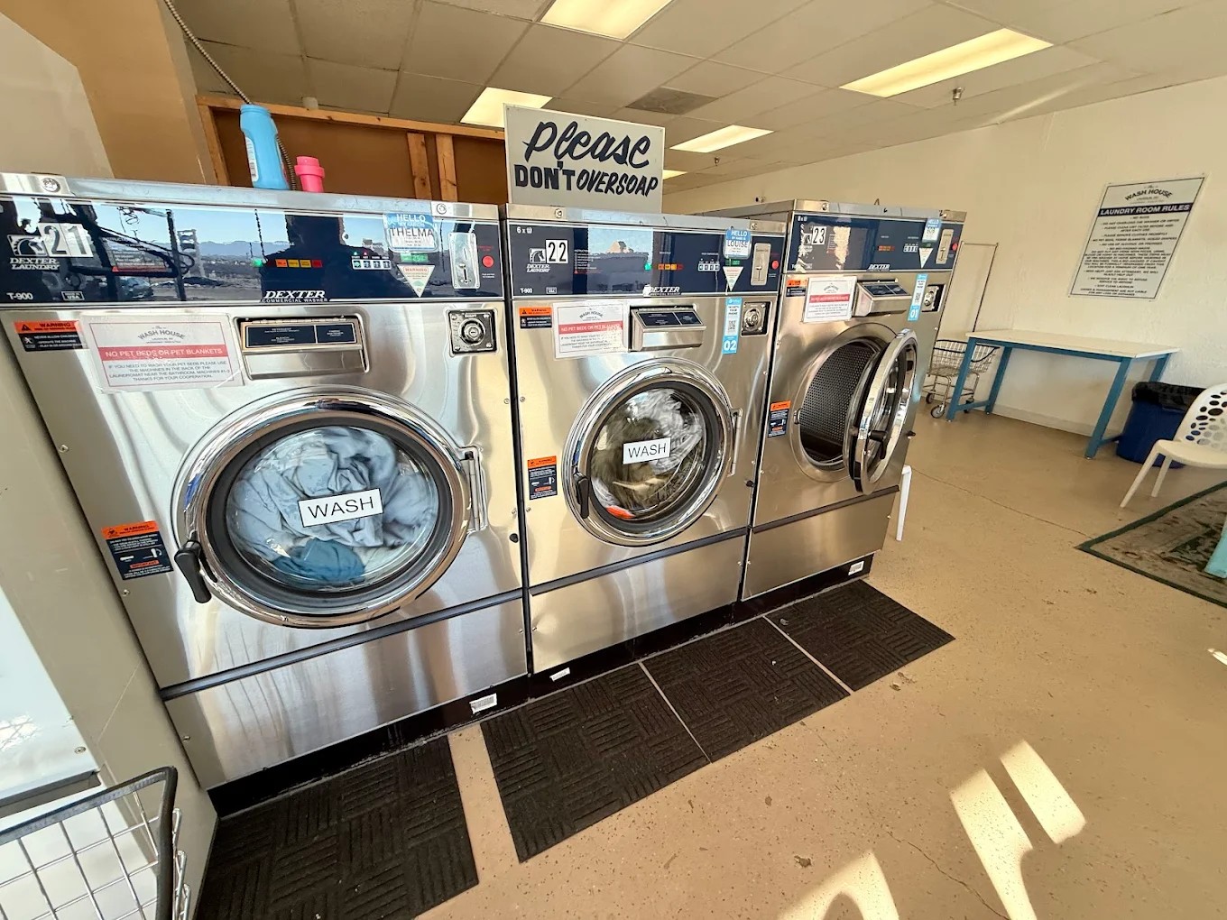 Large stainless washers along the wall at The Wash House Laughlin.